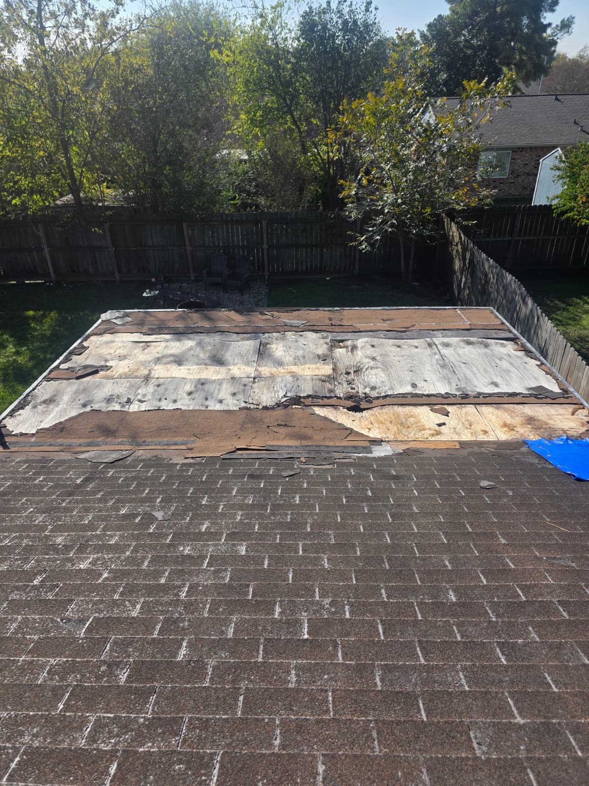 Roof torn off down to the weathered decking before replacement
